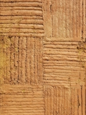 Closeup of texture of The Seamstress pillar. The cross hatched texture refers to fabric in general and shirts.