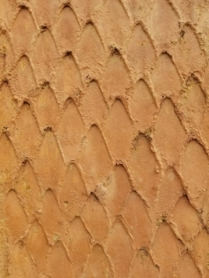 Closeup of texture of The Mason pillar. A mason's trowel was used to create a pattern which refers to the many bricklayers and masons who resided in and built for the community.